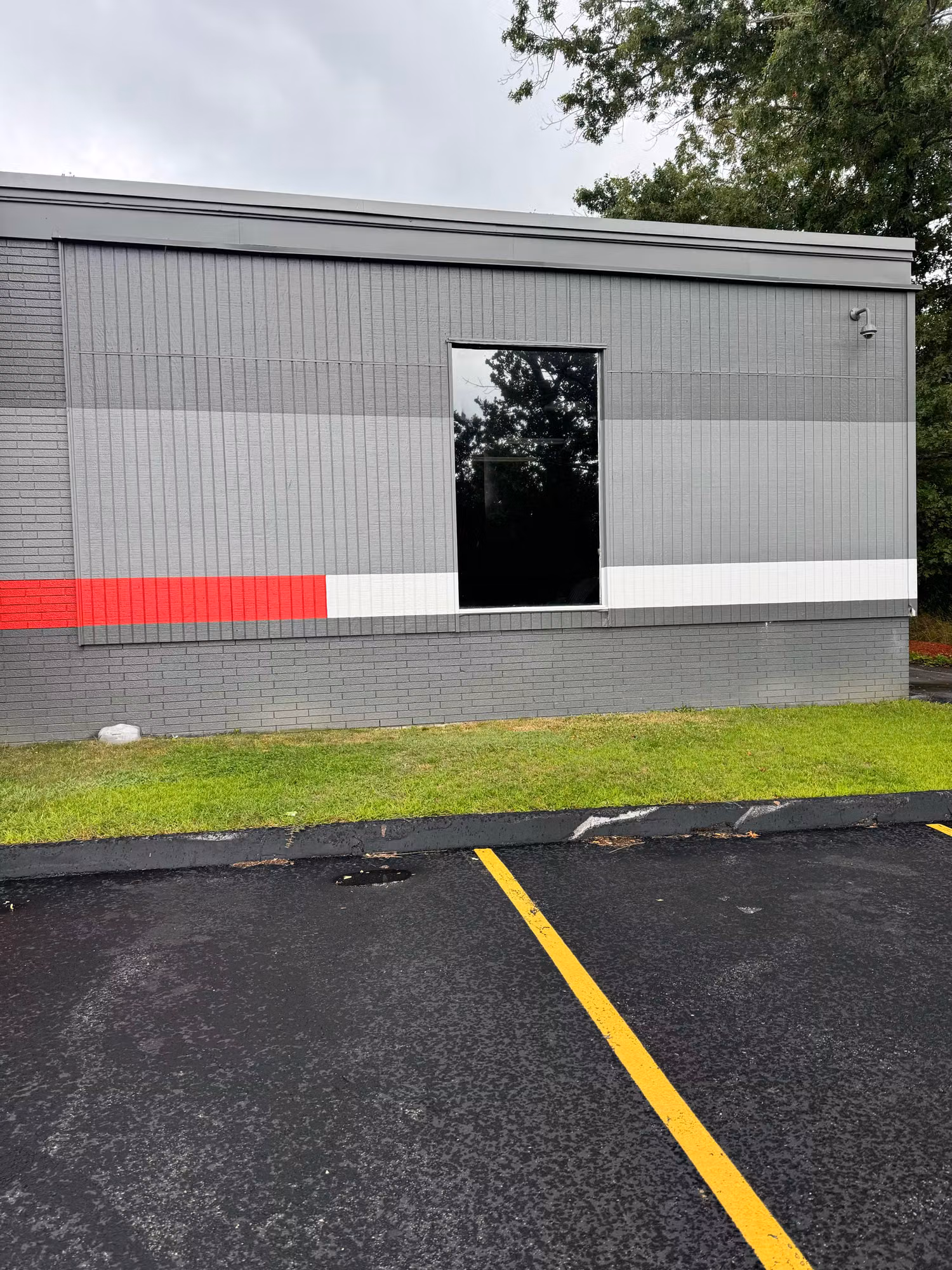 Single side-wall window on a commercial building fitted with darkened window film to cut heat and glare.