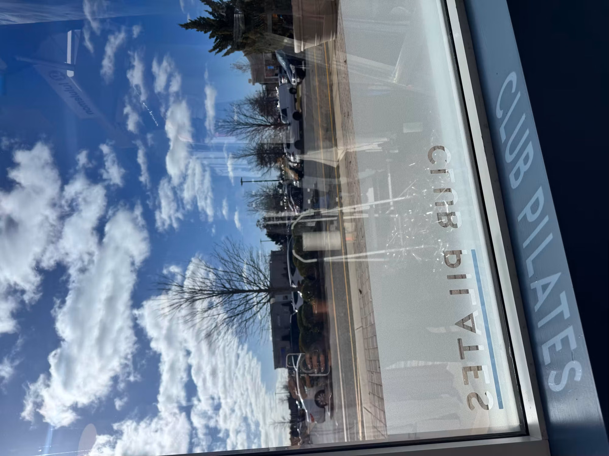 Close-up of an etched lettering band along the lower edge of a storefront window.