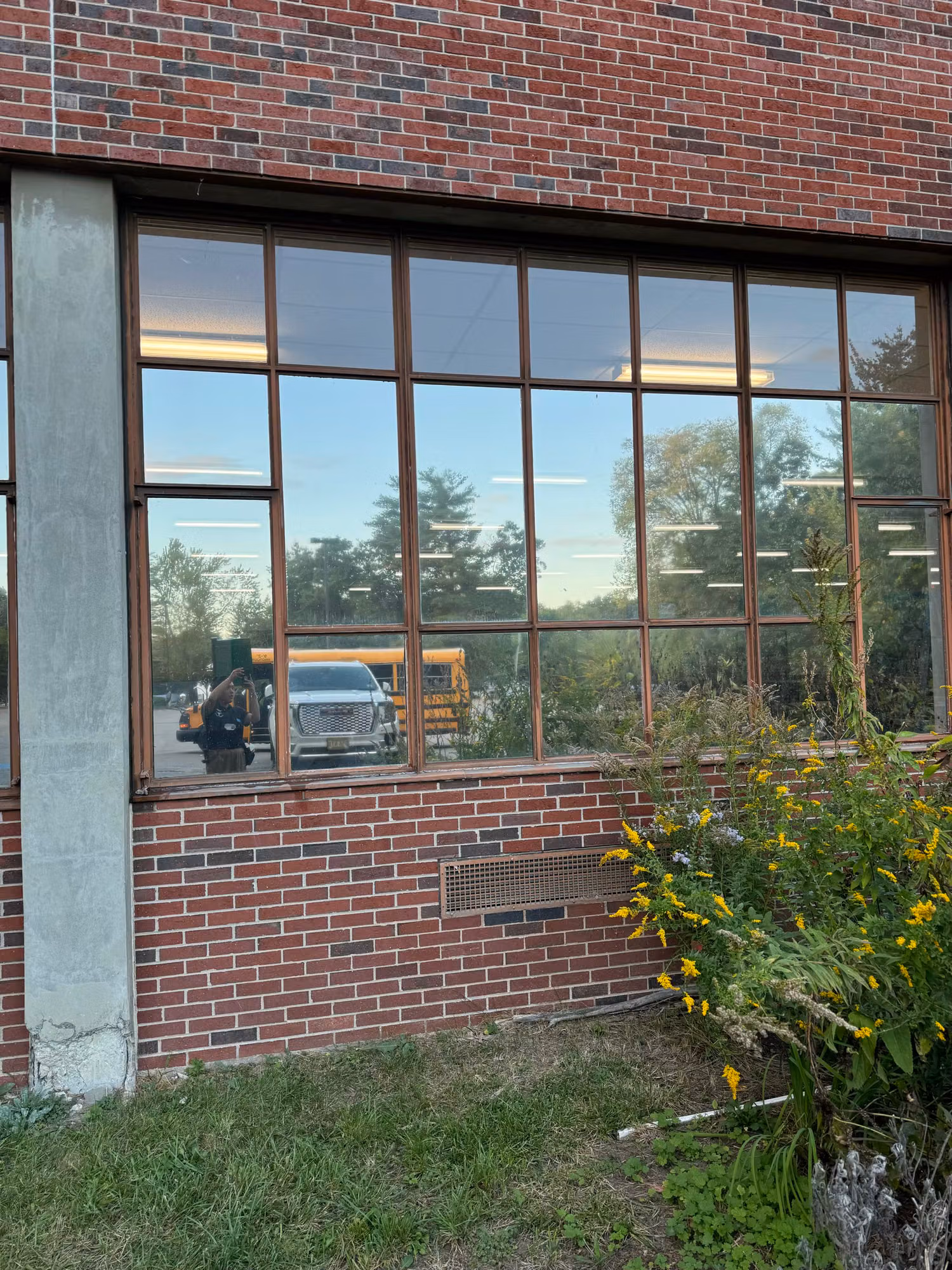 Exterior view of a brick building window finished with reflective solar control film reducing heat and glare.