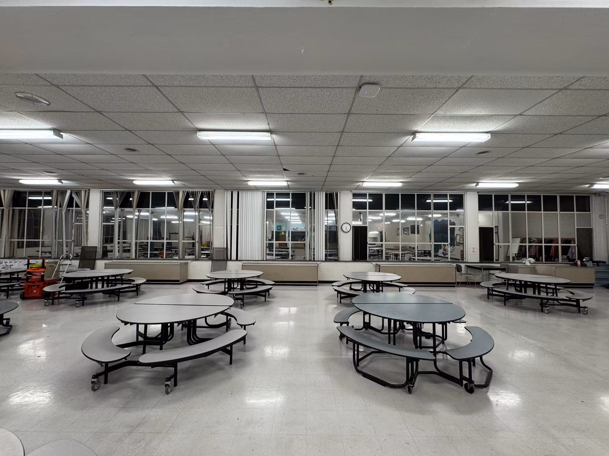 Wide view of a school cafeteria dining hall with a rear window wall treated with solar control film.