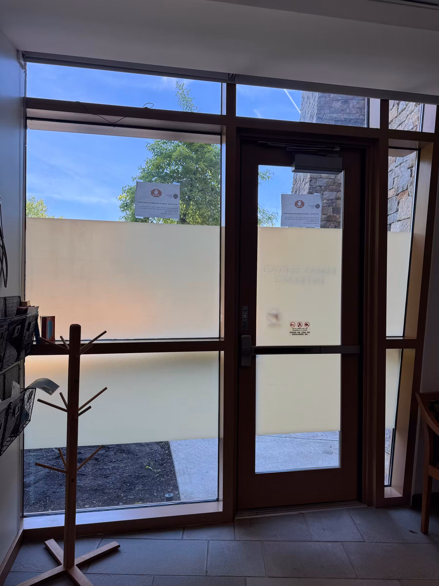 Glass entry door and sidelight with a frosted privacy band applied across the lower glass panels.