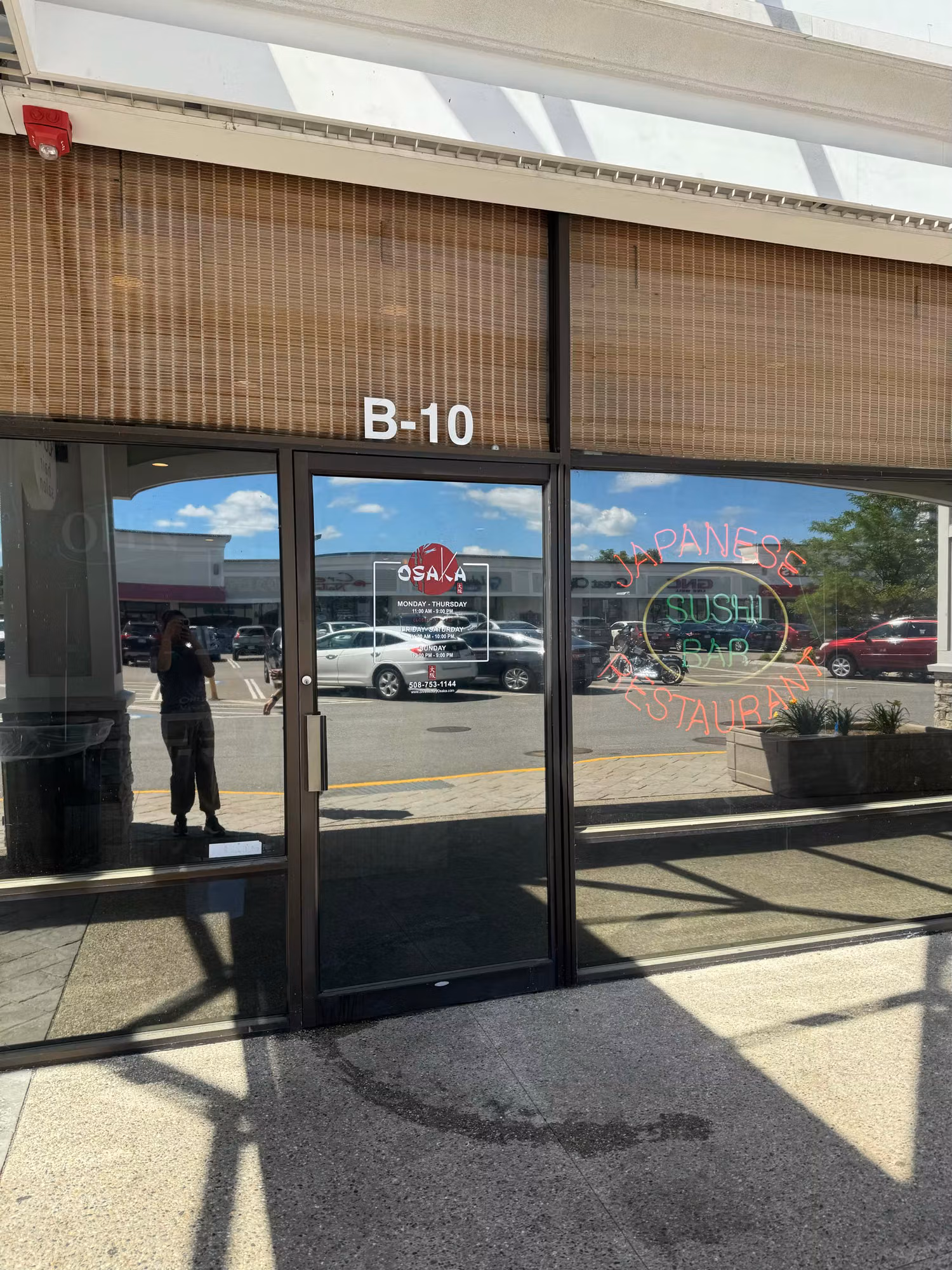 Commercial storefront glass with cut vinyl restaurant lettering and logo graphics applied across the windows.