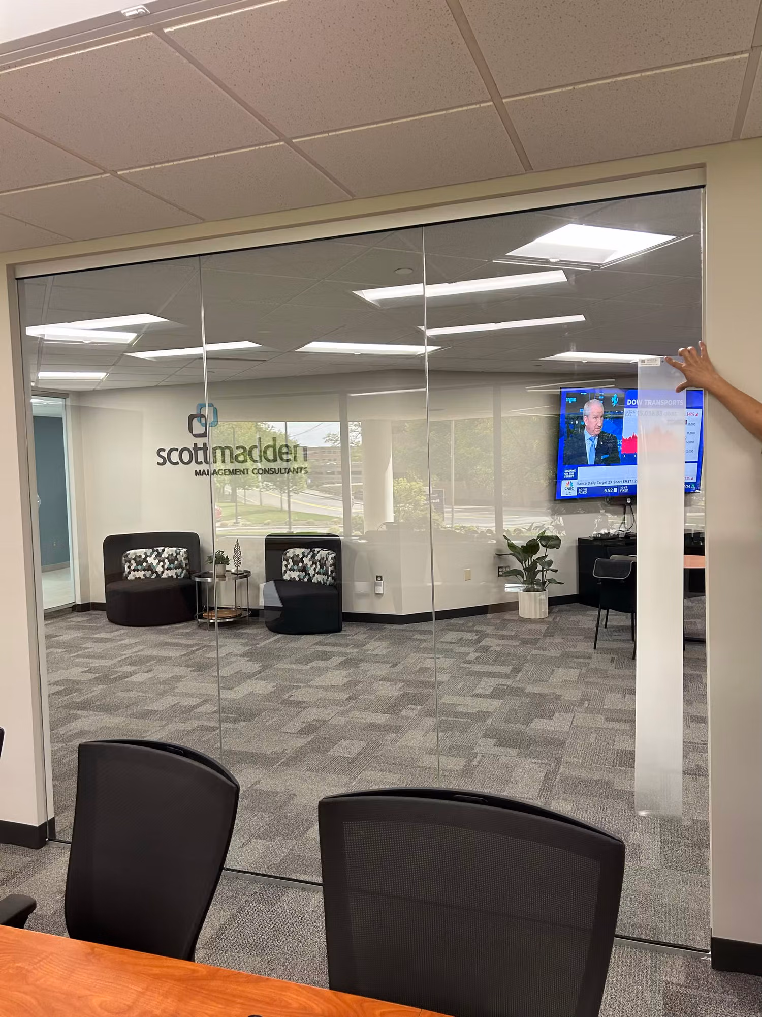 Frosted graphic being applied to a glass conference room partition during a commercial window film installation.