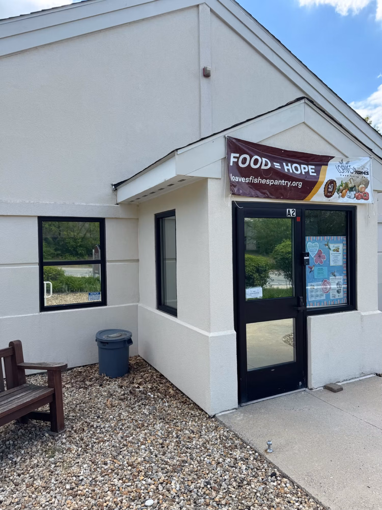 Storefront entry door with full glass beside a side window, both treated with commercial window film.
