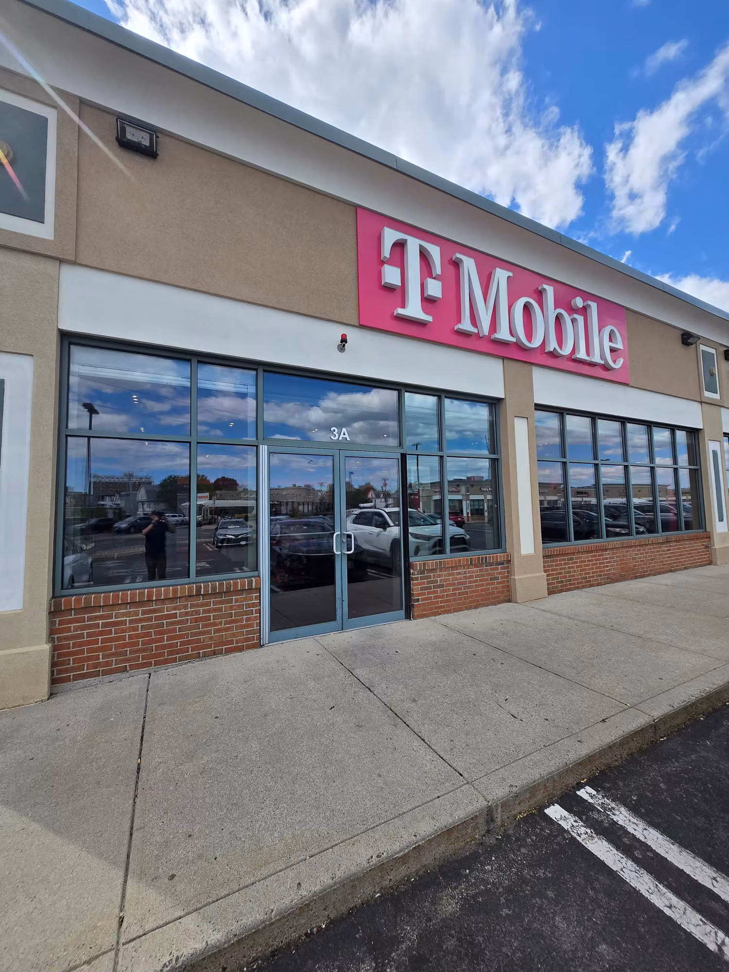 Retail storefront with large reflective glass windows and entry doors fitted with commercial window film.