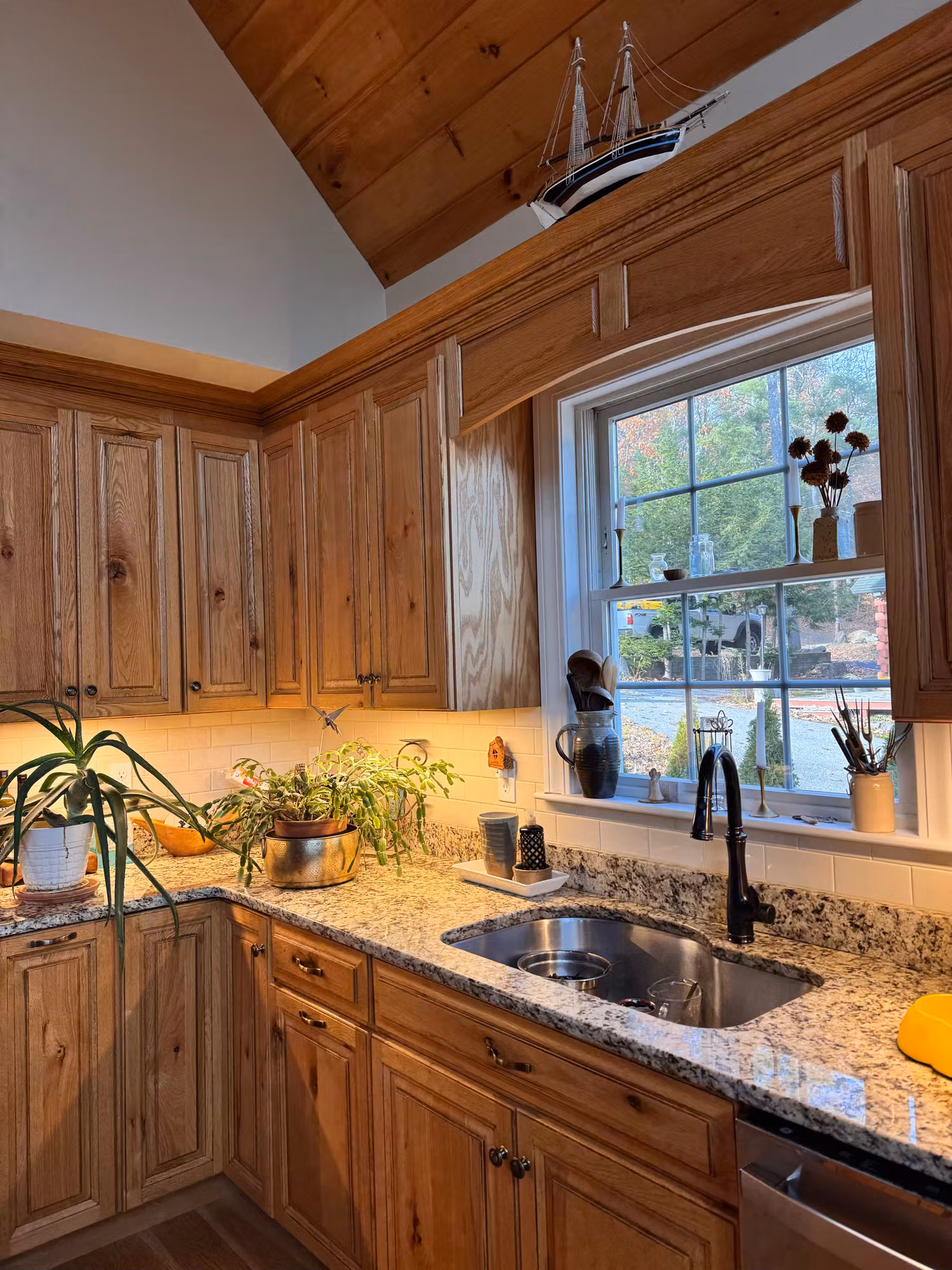 Window over the sink in a wood-cabinet kitchen with film applied to the glass.